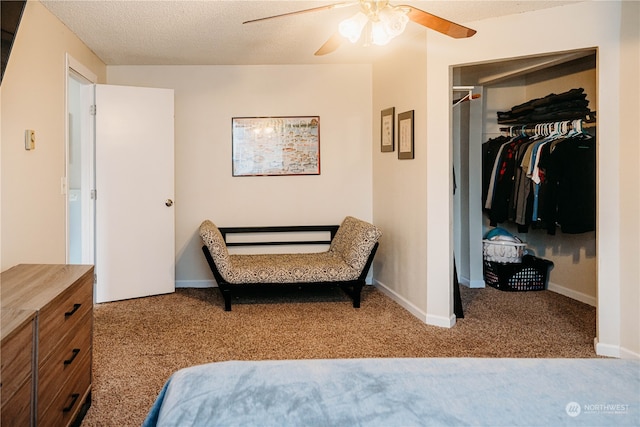 bedroom featuring ceiling fan, a closet, light carpet, and a textured ceiling