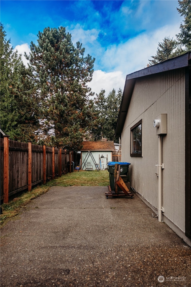 view of yard with a patio and a storage shed