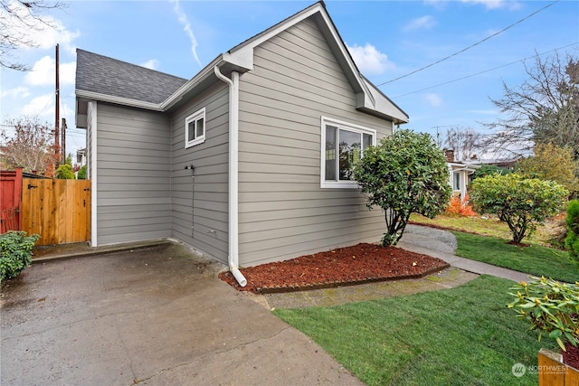 view of home's exterior with a lawn and a patio area