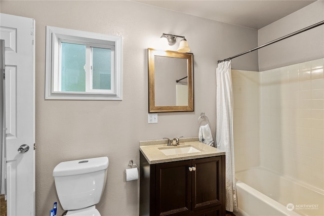 full bathroom featuring shower / bath combination with curtain, vanity, and toilet