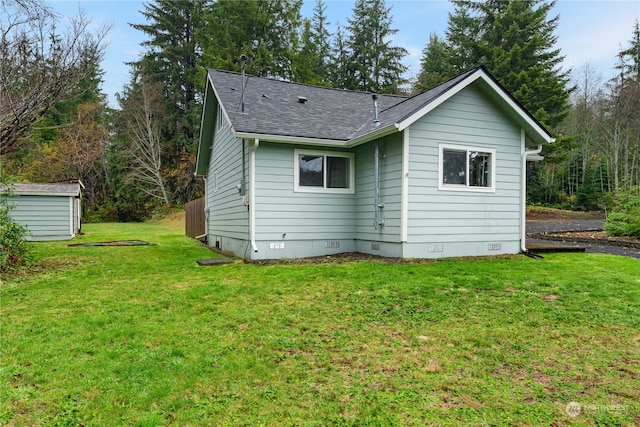 rear view of house featuring a lawn