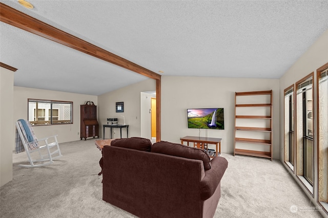 carpeted living room with lofted ceiling with beams and a textured ceiling