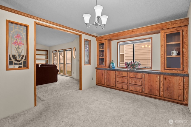 interior space featuring a notable chandelier, crown molding, and a textured ceiling