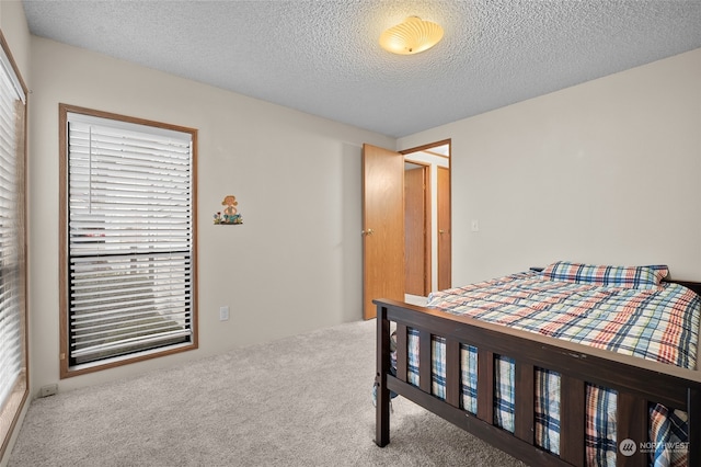 carpeted bedroom featuring a textured ceiling