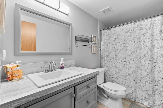 bathroom featuring tile patterned floors, vanity, and toilet