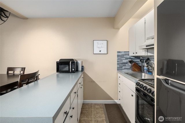 kitchen with black range with electric cooktop, under cabinet range hood, a sink, white cabinetry, and tasteful backsplash