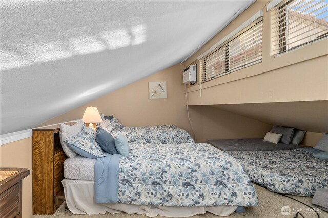 carpeted bedroom with lofted ceiling and a textured ceiling