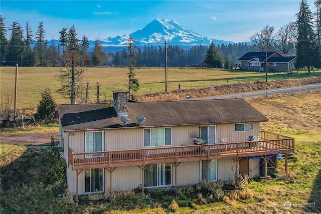 rear view of property with a deck with mountain view