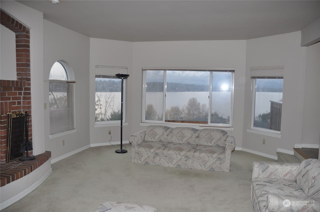 carpeted living room with a brick fireplace