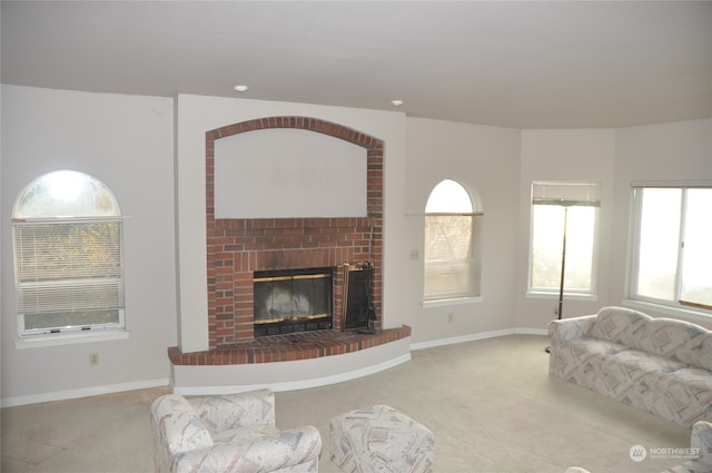 carpeted living room with a brick fireplace