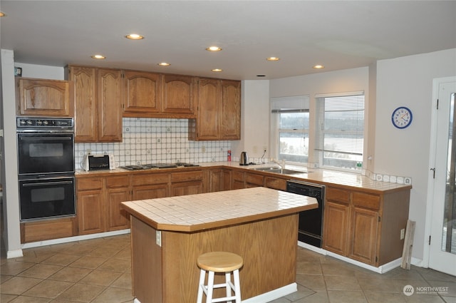 kitchen with tile counters, sink, tile patterned flooring, backsplash, and black appliances