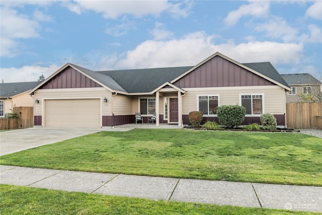 view of front of home featuring a front yard and a garage