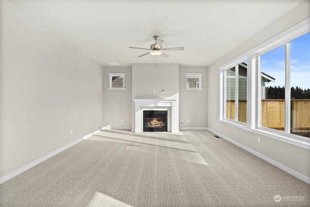 unfurnished living room with light carpet and ceiling fan