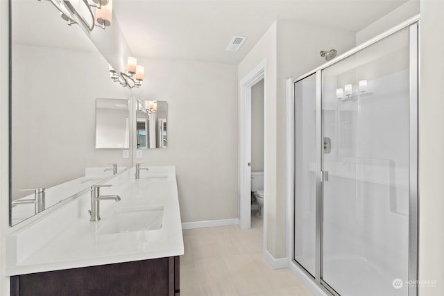 bathroom featuring vanity, an enclosed shower, tile patterned floors, and toilet