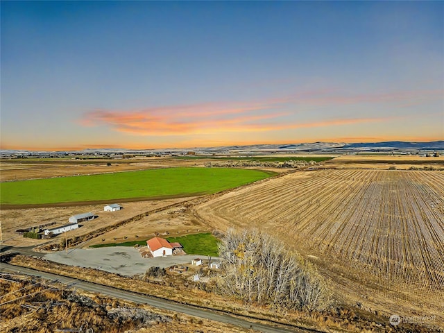 aerial view at dusk featuring a rural view