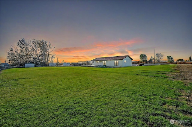 view of yard at dusk