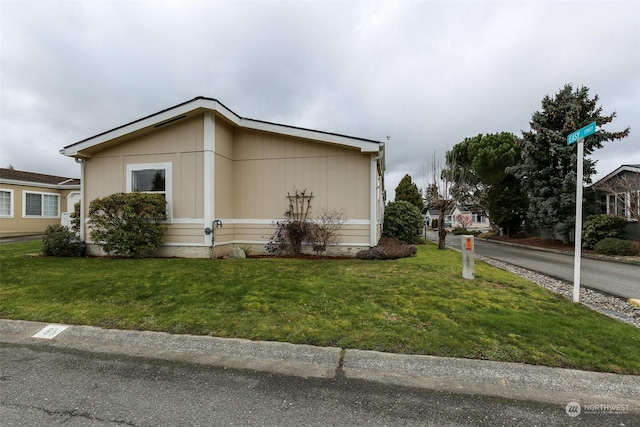 view of side of property with a lawn