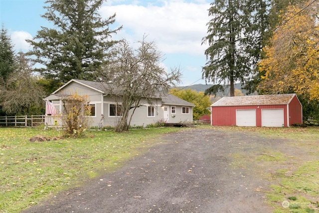 view of front of house with an outbuilding, a garage, and a front yard