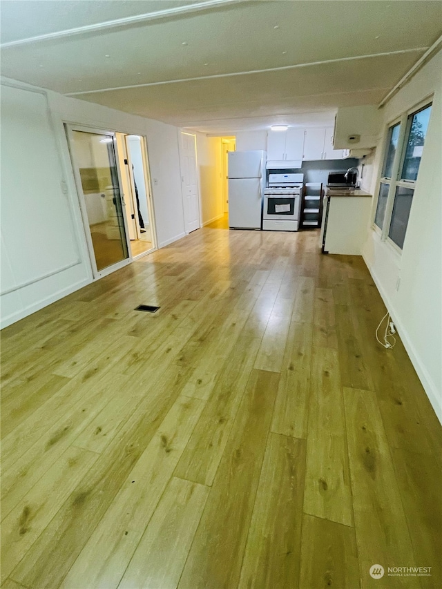 unfurnished living room with light hardwood / wood-style flooring