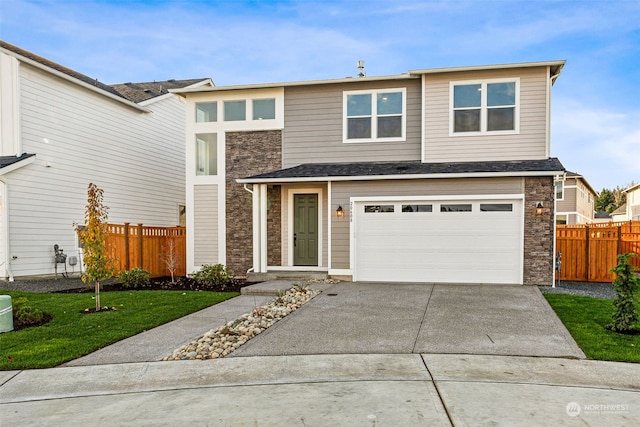 view of front facade featuring a front yard and a garage