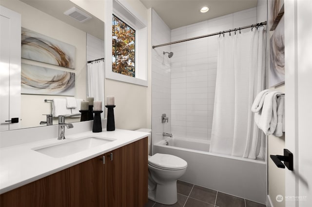 full bathroom featuring tile patterned flooring, vanity, shower / bath combo, and toilet