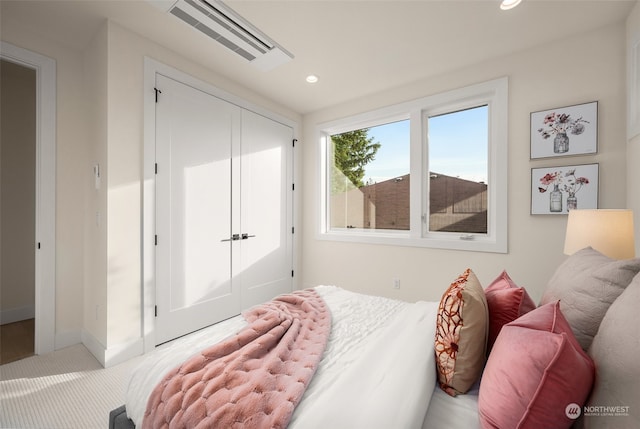 bedroom featuring carpet flooring and a closet