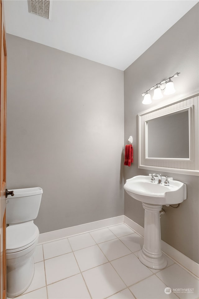 bathroom featuring toilet and tile patterned floors