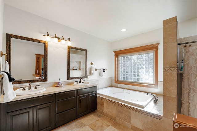 bathroom with vanity and tiled bath