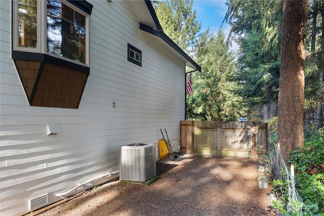 view of side of home with central AC