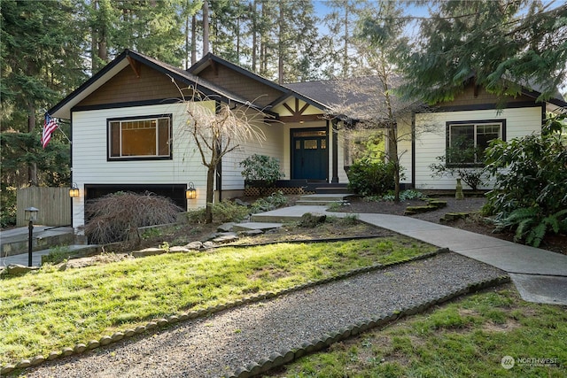 view of front of home with a front lawn and a garage