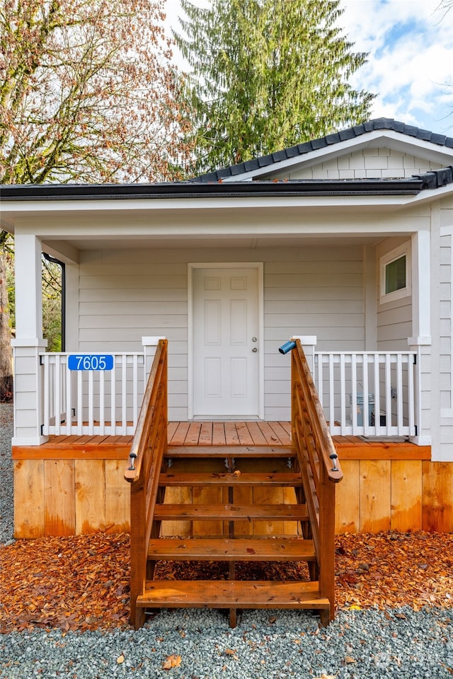 view of exterior entry featuring a porch