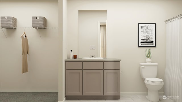 bathroom featuring tile patterned floors, vanity, and toilet