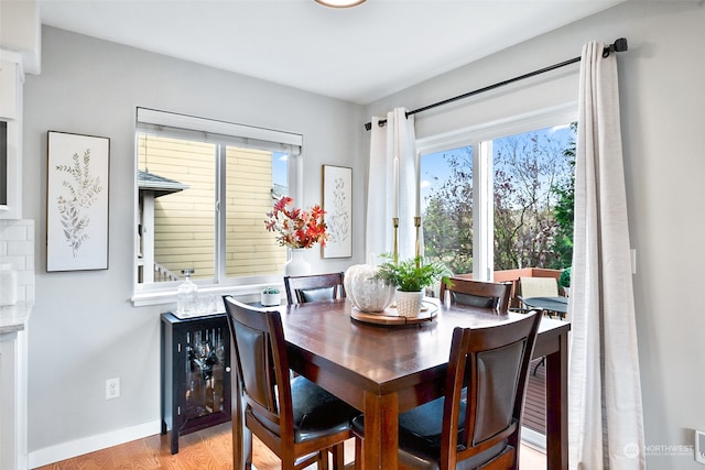 dining space with light hardwood / wood-style flooring