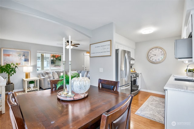 dining room with ceiling fan, light hardwood / wood-style flooring, and sink