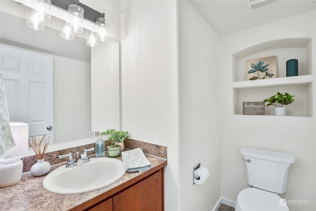 bathroom with vanity and toilet