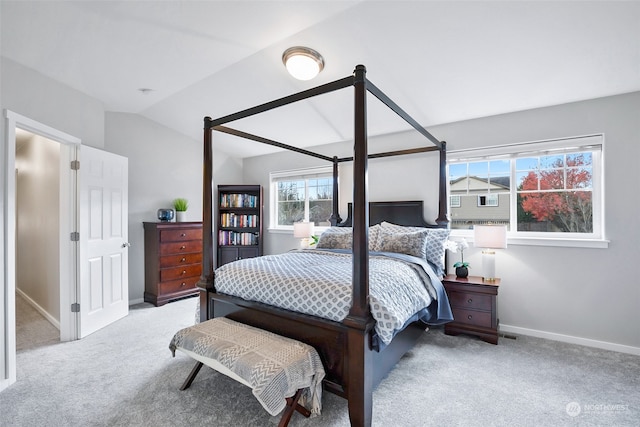 carpeted bedroom featuring lofted ceiling