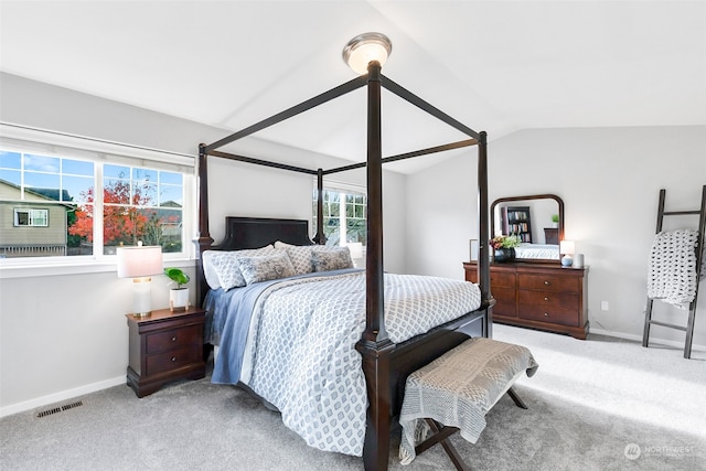 bedroom with carpet flooring, multiple windows, and lofted ceiling