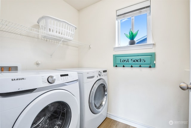 laundry room with light wood-type flooring and independent washer and dryer