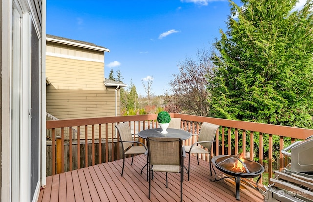 wooden terrace featuring a fire pit