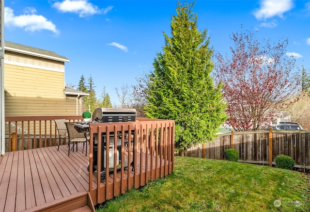 wooden deck with a lawn