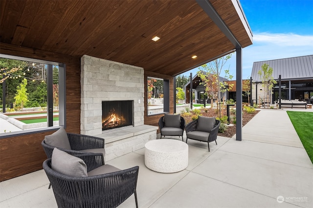 view of patio / terrace featuring an outdoor stone fireplace