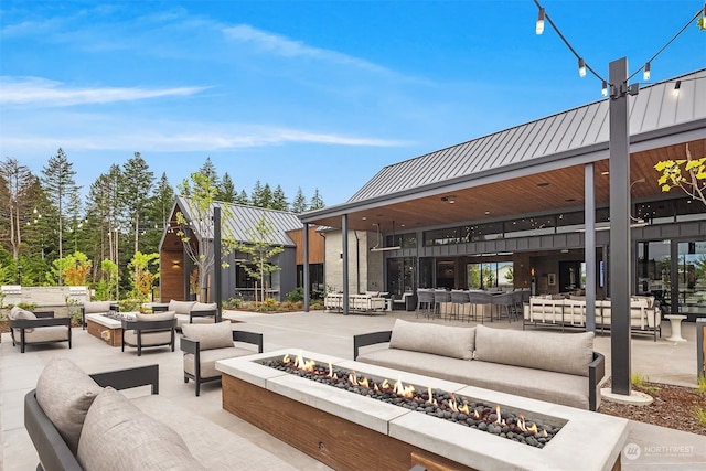 view of patio featuring an outdoor living space with a fire pit