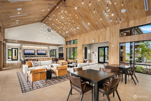 dining area with plenty of natural light, wooden ceiling, and high vaulted ceiling