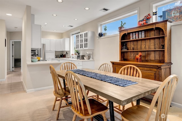 dining room with light colored carpet and sink