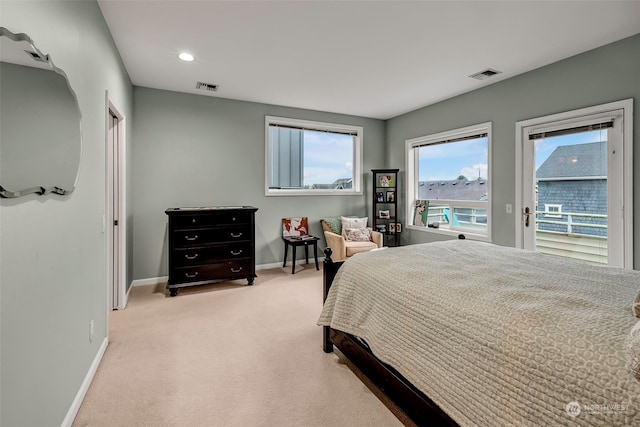 bedroom featuring light carpet and access to outside