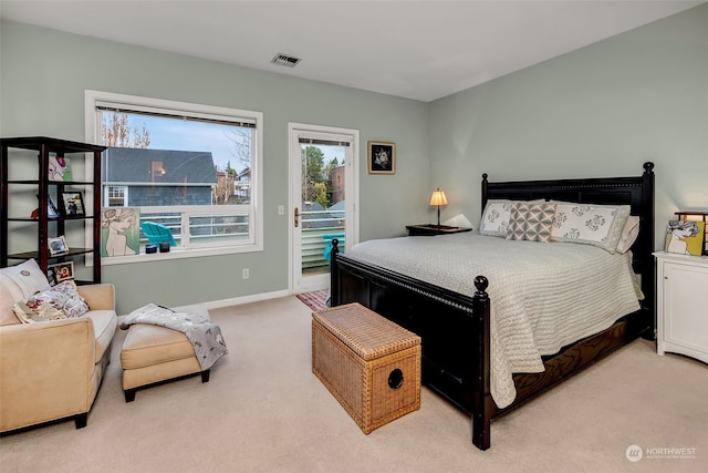 bedroom featuring access to exterior and light colored carpet