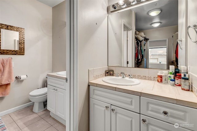 bathroom featuring tile patterned floors, vanity, and toilet