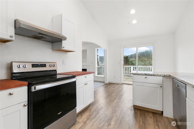 kitchen featuring white cabinets, appliances with stainless steel finishes, light hardwood / wood-style flooring, and range hood