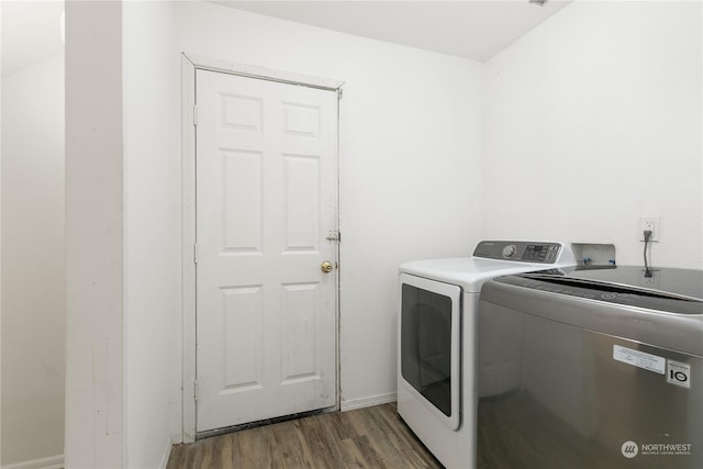 washroom featuring washer and clothes dryer and dark hardwood / wood-style flooring