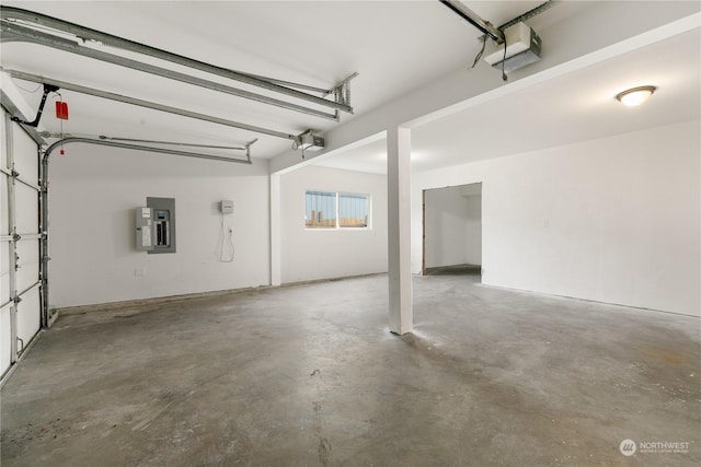 garage featuring electric panel and a garage door opener